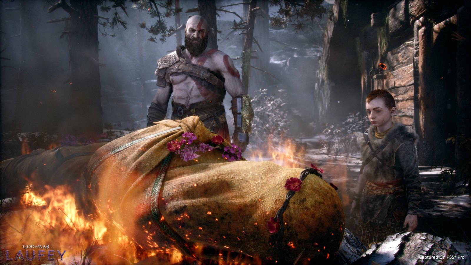 Kratos e Atreus diante de uma pira funerária em God of War Laufey